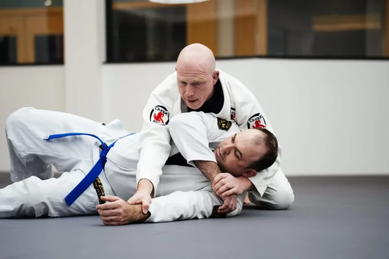 Instructor applying side control during Brazilian Jiu Jitsu classes for beginners