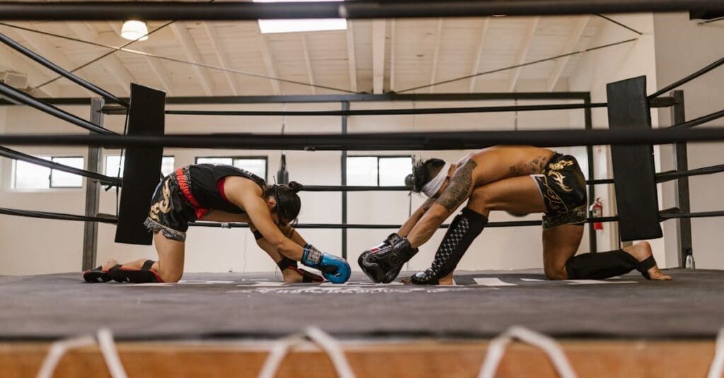 Fighters bowing with gloves before Muay Thai training session