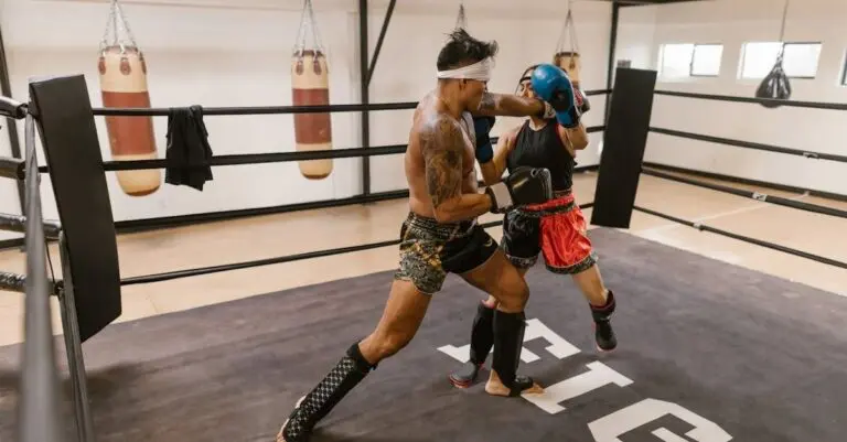 Two muay thai fighters sparring in a ring; a male fighter throws a punch while a female fighter blocks.